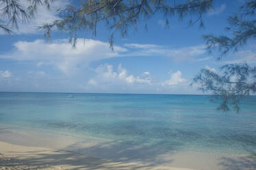 Scenic view of Norman Saunders beach against blue sky at Grand Turk, Turks And Caicos Islands - RUNF03230