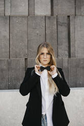 Portrait of blond young woman wearing black tie and blazer, Vienna, Austria - LHPF00963