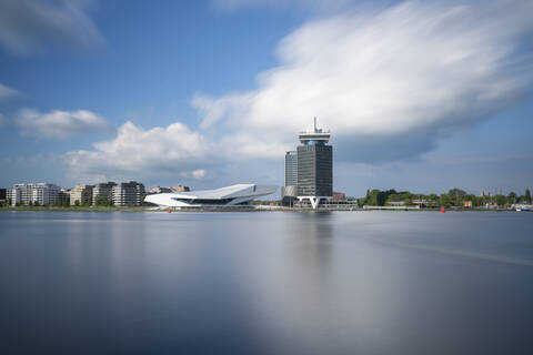 Netherlands, Amsterdam, Large clouds over waterfront city skyline stock photo