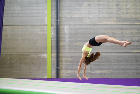 Gymnast exercising on a mat - JSMF01296