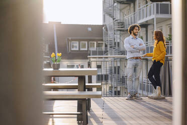 Two colleagues talking on roof terrace - KNSF06603