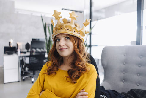 Businesswoman in office wearing a crown - KNSF06648
