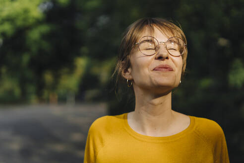 Portrait of content young woman with closed eyes - KNSF06694