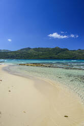 Scenic view of sea and mountain against blue sky during sunny day, Playa Rincon, Dominican Republic - RUNF03275