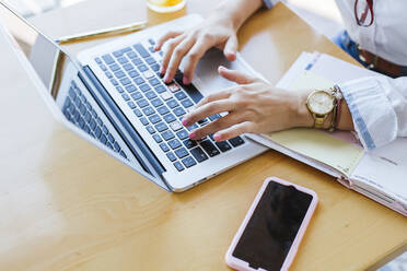 Hands of young woman using laptop on table - LJF01052