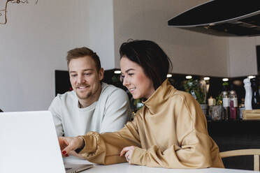 Young couple using laptop - JOHF00980