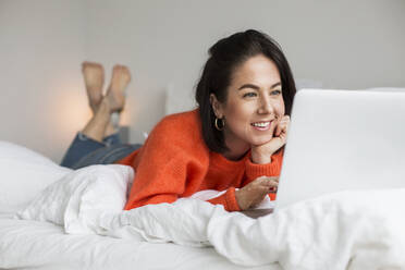 Smiling woman on bed - JOHF00984