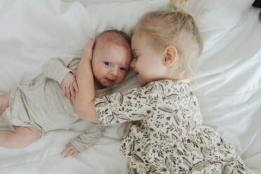 Girl hugging baby sibling - JOHF01075