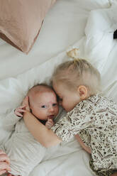 Girl hugging baby sibling - JOHF01076
