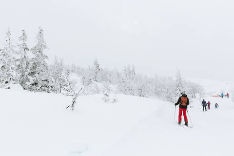 Skiers in mountains stock photo