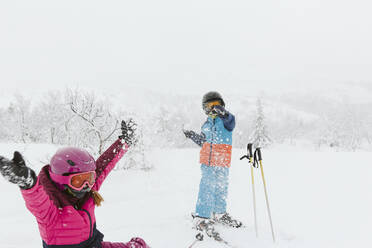 Boy and girl on ski slope - JOHF01257