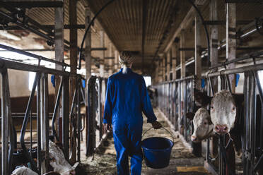 Woman in cowshed - JOHF01323