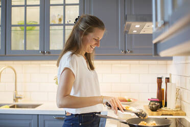 Woman preparing food in kitchen - JOHF01341