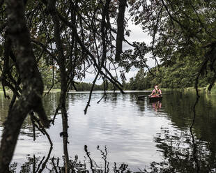 Man kayaking on river - JOHF01390