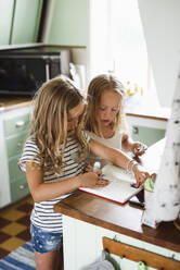 Two girls with notebook - JOHF01410