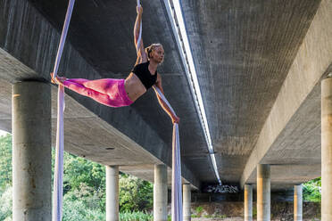 Woman doing aerial yoga - JOHF01467