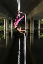 Woman doing aerial yoga - JOHF01469