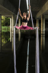 Woman doing aerial yoga - JOHF01470