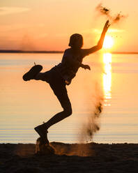 Boy playing on beach - JOHF01710