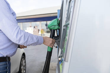 Hand holding petrol pump - JOHF01777