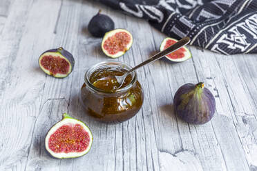 Sliced figs and jar of homemade fig jam - SARF04354