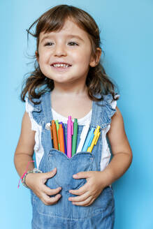 Portrait of cute little girl with colored ballpoint pens on her pocket - GEMF03188