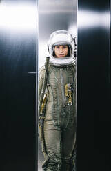 Man posing dressed as an astronaut in an elevator - DAMF00090