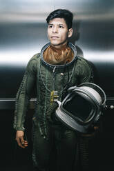 Man posing dressed as an astronaut in an elevator - DAMF00102