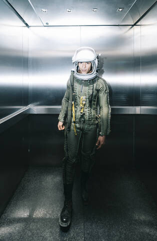Man posing dressed as an astronaut in an elevator stock photo