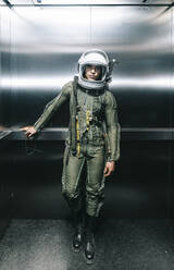 Man posing dressed as an astronaut in an elevator - DAMF00104