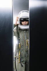 Man posing dressed as an astronaut in an elevator - DAMF00106