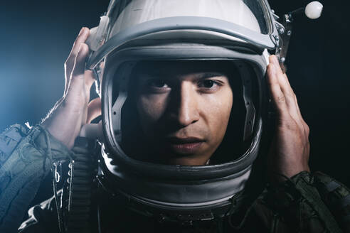 Man posing dressed as an astronaut in skyrocket elevator - DAMF00108
