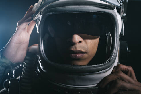 Man posing dressed as an astronaut in skyrocket elevator - DAMF00109