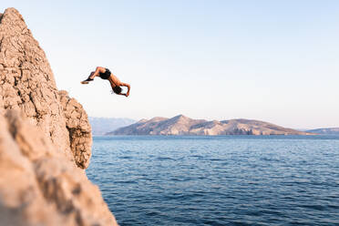 Croatia, Krk, man diving into sea - WVF01437