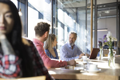 Casual business people having a meeting in a cafe - FKF03650