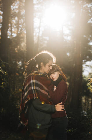 Young couple in love in forest stock photo