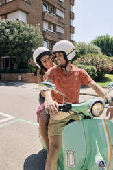 Young couple on a vintage motor scooter - JNDF00118