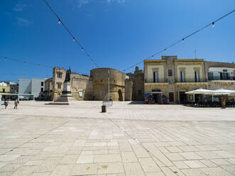 Italy, Province of Lecce, Otranto, String lights hanging over monument of female martyr on Piazza degli Eroi - AMF07325