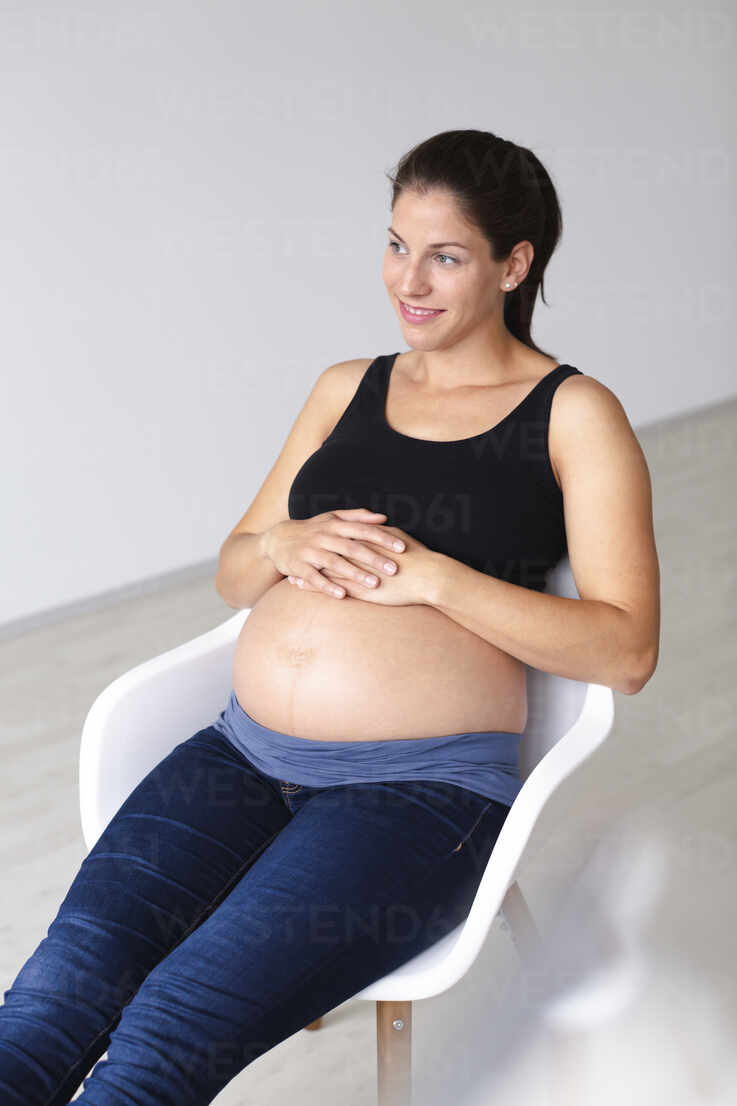https://us.images.westend61.de/0001262579pw/young-pregnant-woman-sitting-on-chair-and-is-thinking-about-the-future-HMEF00600.jpg