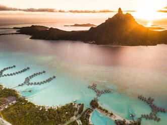 Aerial view of Bora Bora with red sunset light on Mount Otemanu in French Polynesia - AAEF03798