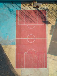 Aerial view of a vintage colorful basketball court in Pozo Negro in Fuerteventura, Canary Islands. - AAEF03829