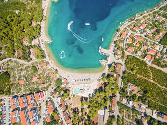 Aerial view of housing estate and beach at Necujam bay at Solta, Croatia. - AAEF03955