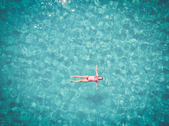 Schöne Frau schwimmt in transparentem Meer - AAEF04121