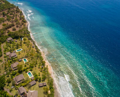 GEROKGAK, BALI - 21 AUGUST 2017: Aerial panoramic view of Puri Ganesha Homes with swimming pools by coast, Gerokgak, Bali. - AAEF04322