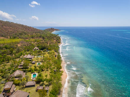 GEROKGAK, BALI - 21 AUGUST 2017: Aerial panoramic view of Puri Ganesha Homes with swimming pools by coast, Gerokgak, Bali. - AAEF04349