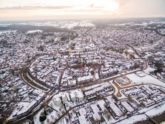Aerial view of snow cityscape during scenic sunset, Lochem, Netherlands. - AAEF04437