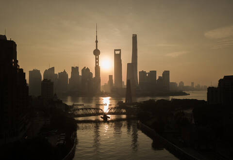 Aerial view of Shanghai skyline at sunset with passing Huangpu river, China. stock photo