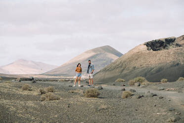 Couple posing outside the Volcano Cuervo in Lanzarote, Timanfaya. - CAVF63335