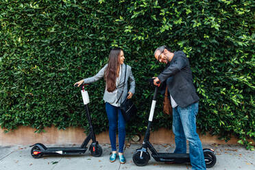 Man and Woman with Electric Scooter - CAVF64065