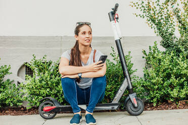 Woman Sits on Scooter - CAVF64085